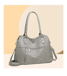 Detail of grey soft leather shoulder bag with silver hardware and adjustable straps