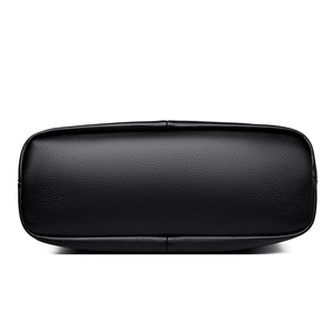 Bottom view of black pebble leather shoulder bag with reinforced stitching details