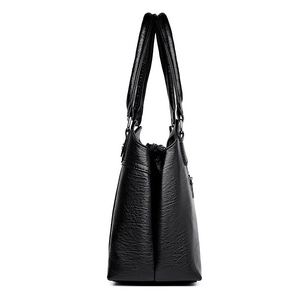 Borsa a mano da donna in pelle martellata nera con design a fisarmonica a più strati
