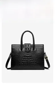Detail view of black crocodile pattern faux leather texture on large tote handbag