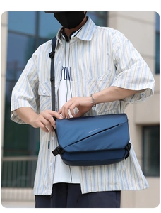 Detail of dark blue waterproof messenger bag with white Move to Future text and buckle