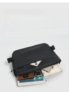 Internal compartments of waterproof black crossbody bag showing organized tech storage
