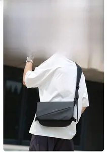 Detail of wide padded shoulder strap and 3D breathable mesh on black crossbody bag