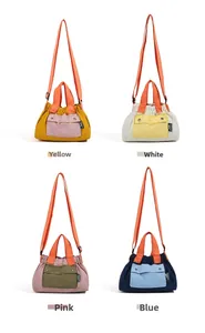 Detail view of four-color nylon crossbody bags with contrasting straps and front pocket