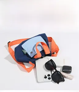 Top view of multi-color nylon bag showing storage capacity with phone and accessories