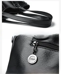 Détails des poignées et de la quincaillerie d'un sac cabas noir en cuir grainé avec logo