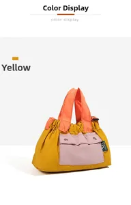 Detail of color-block nylon tote bag with pleated fabric and contrast front pocket