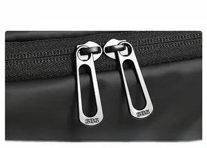 Detailed macro view of high-quality SBS dual metal zippers on waterproof black fabric