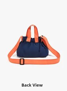 Detailed back view of nylon crossbody bag in navy blue with orange adjustable straps