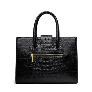 Black crocodile embossed tote bag with gold zipper and top handle for women