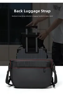 Detail of the back luggage strap on a black waterproof crossbody bag for travel