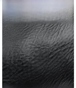 Close-up of durable black litchi grain leather fabric with soft and wear-resistant texture