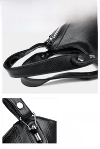 Close-up of reinforced handles and metal ring hardware on black textured leather bag