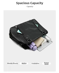 Detail view of large capacity black lychee leather bag holding daily travel essentials