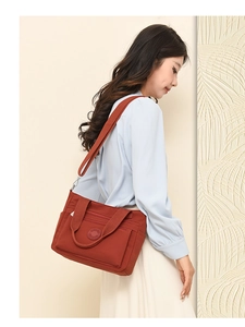 Detailed view of a brown nylon tote bag with adjustable shoulder strap and multiple pockets
