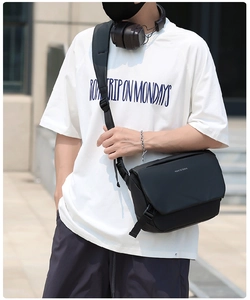 Close-up of black waterproof messenger bag featuring 'move to future' text in street style