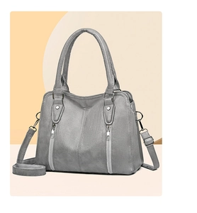 Close-up of gray PU leather texture and silver zipper details on the tote bag