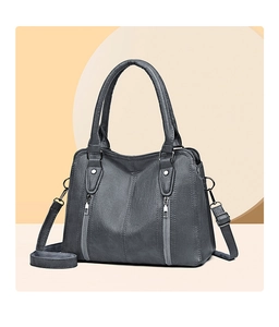 Detail of dark grey handbag with dual zippers, pebbled leather texture and silver hardware