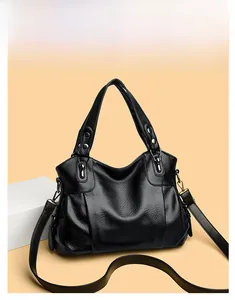 Close-up of black litchi leather tote bag with vintage bronze hardware and sturdy handles