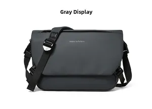 Detail view of grey waterproof messenger bag featuring 'move to future' slogan and wide strap
