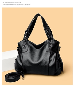 Close-up of black litchi pattern leather texture with silver hardware on tote bag