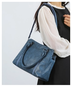 Detail view of the retro blue textured shoulder bag with vertical zipper and large capacity