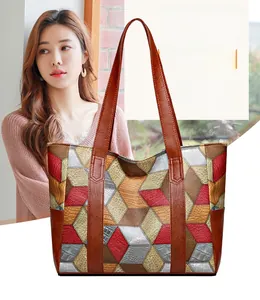 Detail of multi-color geometric patchwork tote bag in textured PU leather with handles