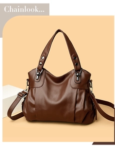 Detail of dark brown faux leather tote with litchi texture and metal rivet handles