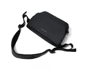 Top view of black waterproof messenger bag with move to future print and wide strap