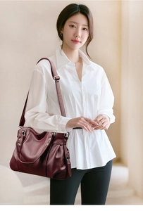 Deep red tote bag featuring lychee grain leather texture and adjustable shoulder strap