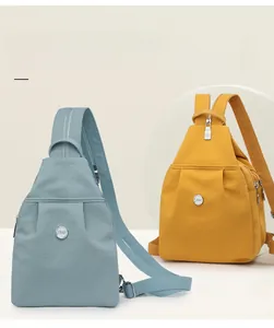 Detail of stylish nylon crossbody bags in blue and yellow with ZMR logo and zipper