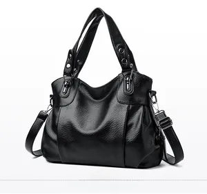 Side view detail of black large capacity PU leather handbag with silver metal hardware