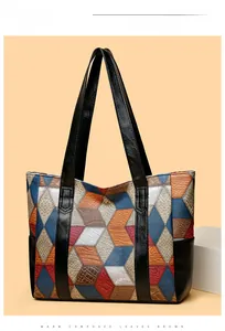 Close-up of geometric patchwork tote bag with lychee and crocodile skin textures