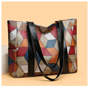Close-up of geometric patchwork leather with 3D crocodile and litchi grain textures