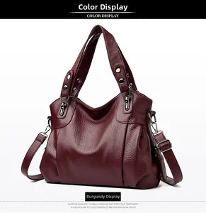 Detail of burgundy pebbled leather handbag featuring silver hardware and soft texture