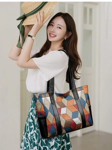 Close-up of geometric pattern PU leather tote bag with sturdy black top handles