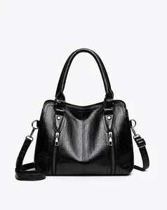 Front view of black PU leather handbag with lychee texture and silver metal hardware details