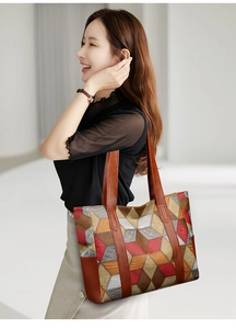 Detailed shot of a geometric patchwork tote bag with stylish multi-color PU leather patterns