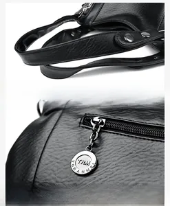 Detail of lychee pattern leather handbag with reinforced handle and branded metal zipper