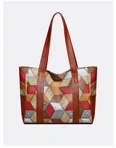 Detail of multi-color PU leather tote bag with geometric patchwork and textured patterns