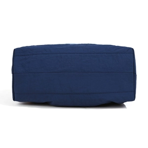 Bottom view of navy blue nylon crossbody bag with durable fabric and reinforced stitching