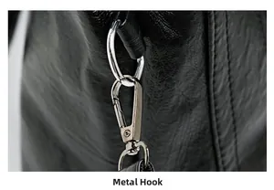 Detail of durable silver metal hook hardware on textured black leather shoulder bag