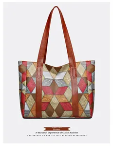 Detail of multi-color geometric patchwork on brown embossed faux leather tote bag