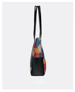 Side view of large geometric color block tote bag with black lychee leather details