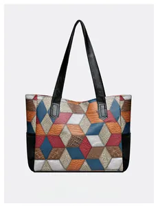 Detailed view of multicolored patchwork tote bag featuring crocodile textures and stitching