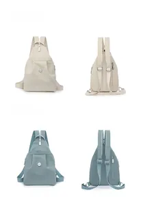 Detail view of white and blue nylon backpacks showing front and back with adjustable straps