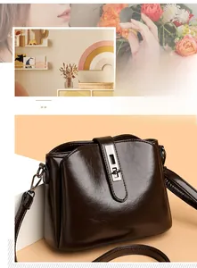 Close-up of dark brown vintage faux leather shoulder bag with a silver rectangular metal lock