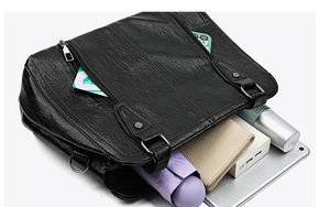 Top view of spacious black tote bag interior showing daily essentials and storage capacity