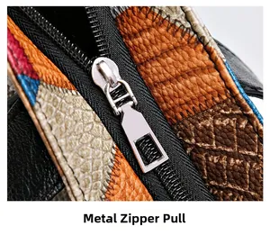 Macro shot of silver hardware zipper and patchwork faux leather texture on the tote bag