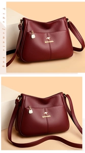 Detail of the golden kangaroo logo and high-quality hardware on burgundy leather bag